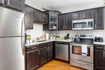 Kitchen with stainless steel appliances and black cabinets